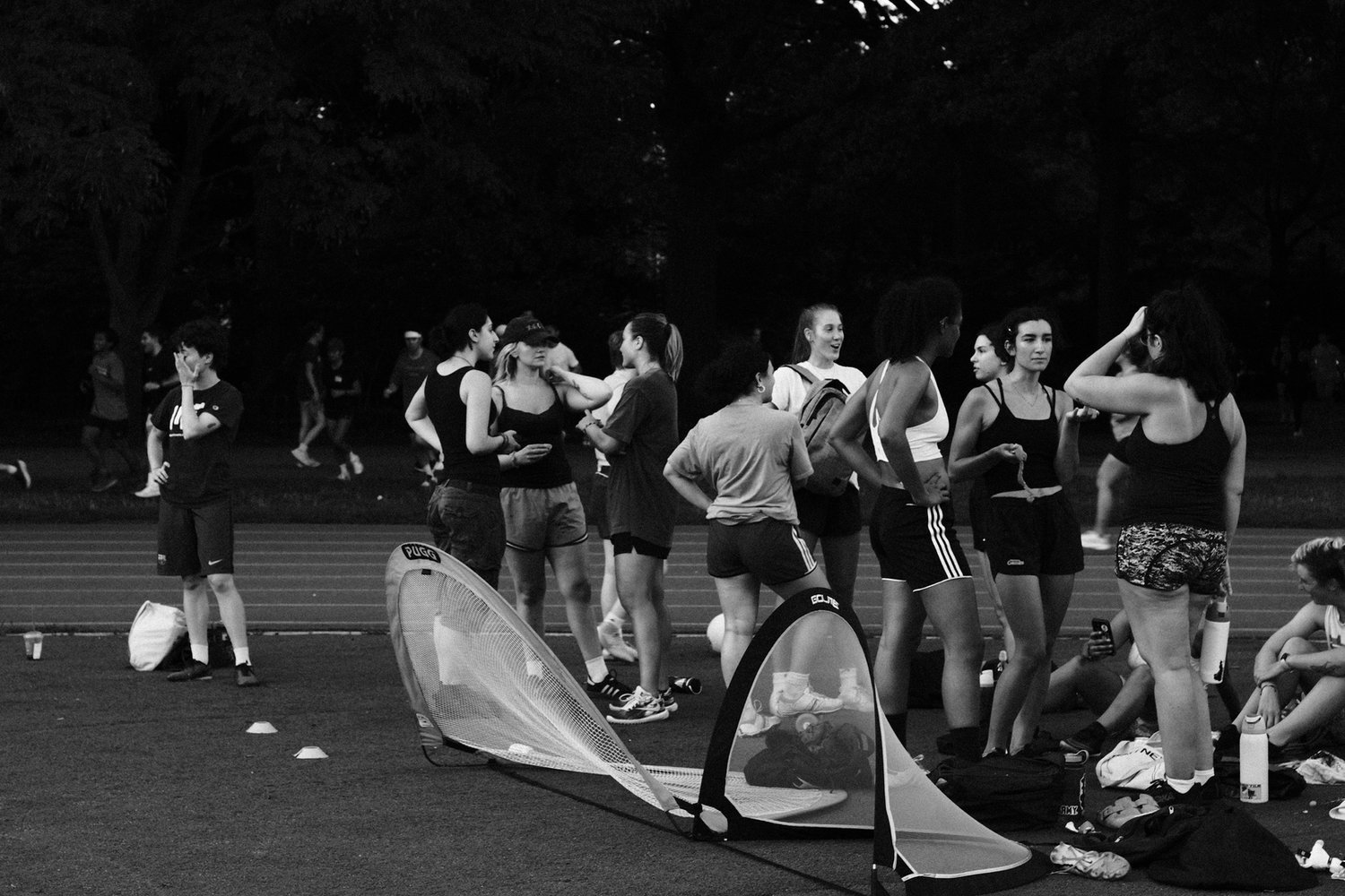 A Footy with Friends group gathered on the pitch at golden hour